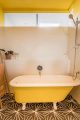 vasca da bagno vintage con piedini dipinta di giallo
