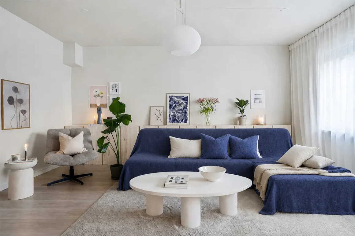 Copri divano blu in soggiorno moderno con arredi chiari e stile contemporaneo