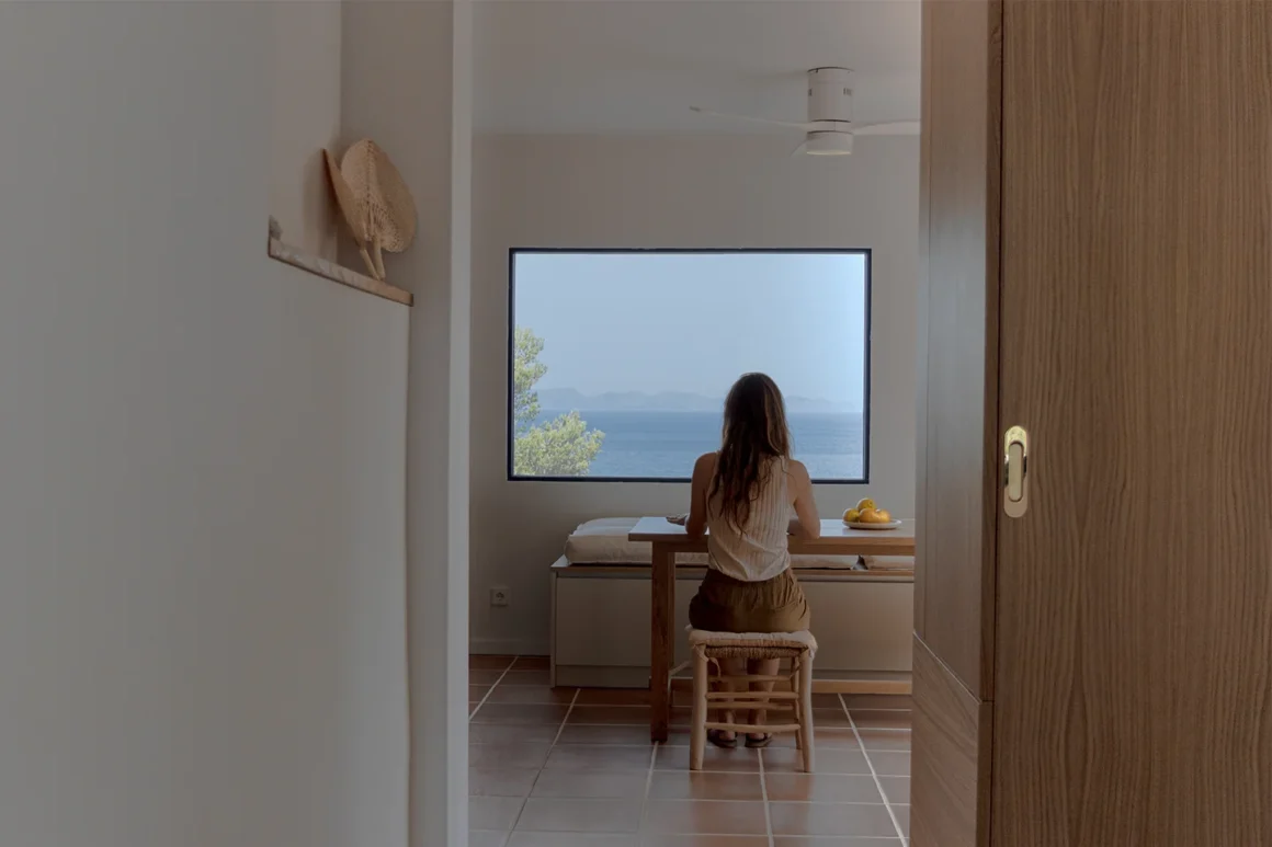 Ristrutturazione appartamento vista mare Maiorca: zona pranzo con finestra panoramica, progetto Up Design Mallorca a Betlem